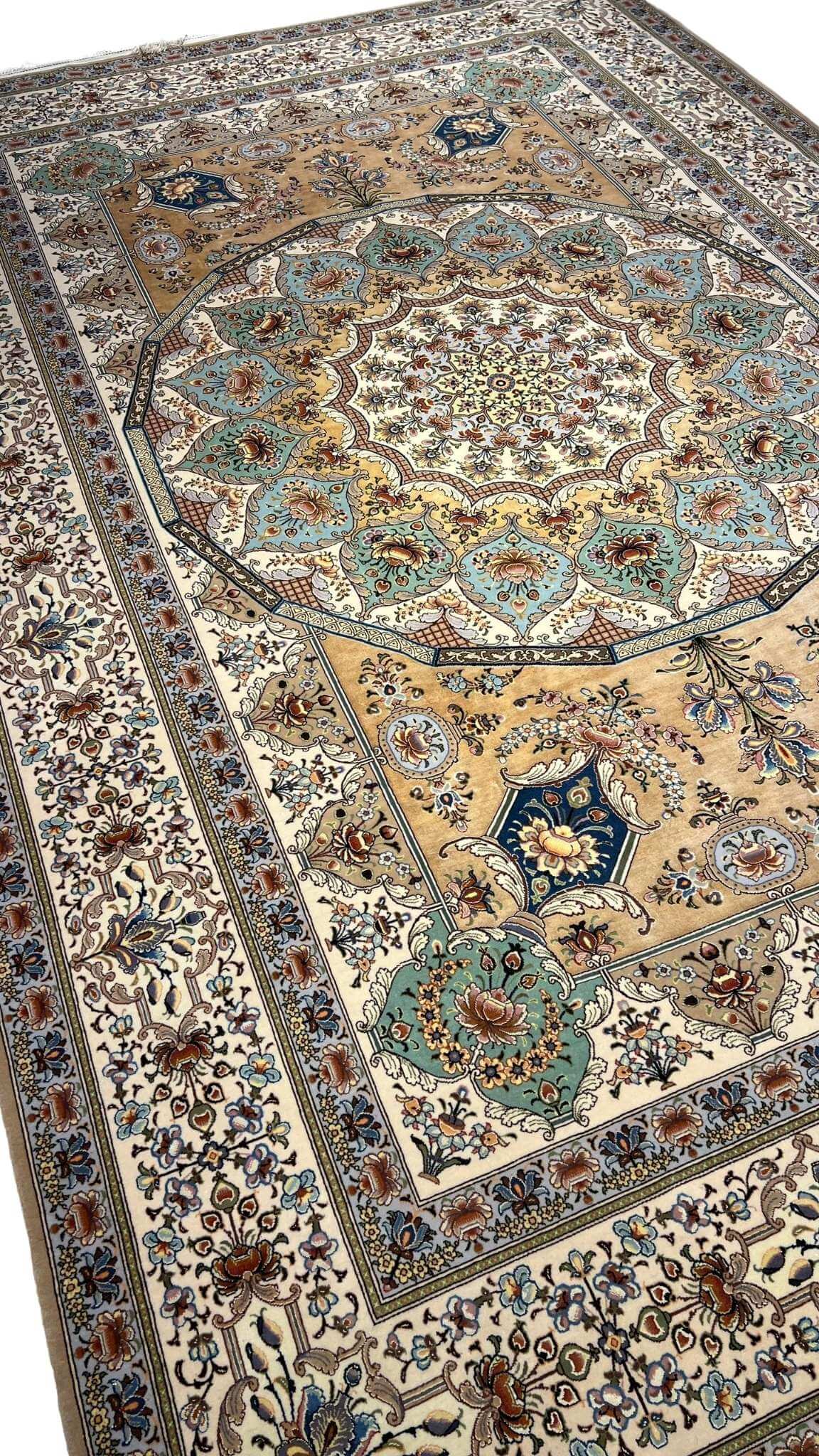"Luxurious wool and silk Persian rug in ivory, gold, and teal tones, crafted in Isfahan, Iran."